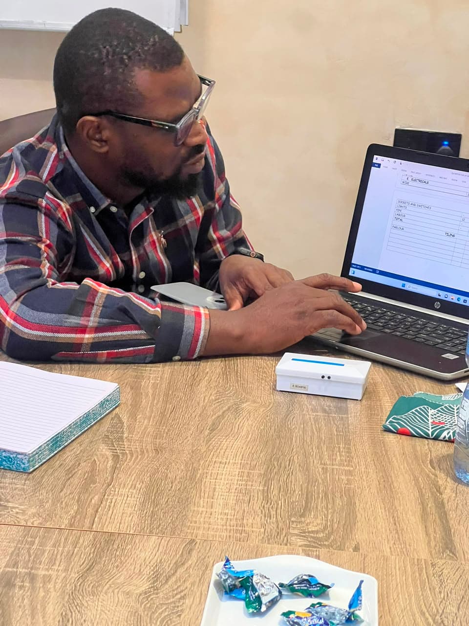 Interior design student creating a digital design project on a laptop at Prefect Home Academy Enugu