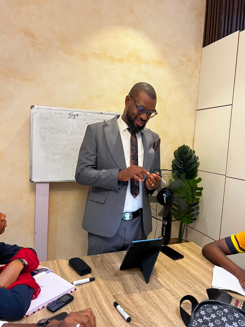 Interior design instructor teaching students at a whiteboard during a professional training session in Enugu